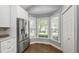 Bright kitchen area featuring stainless steel refrigerator and a bay window that provides natural light at 115 Heatherwood Dr, Apex, NC 27502