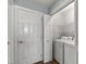 Laundry room with white washer and dryer and wire shelving at 115 Heatherwood Dr, Apex, NC 27502