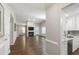 Open-concept living room with a fireplace, hardwood floors, and seamless access to the modern kitchen at 115 Heatherwood Dr, Apex, NC 27502