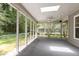 Relax on this screened porch with ceiling fan overlooking the yard at 115 Heatherwood Dr, Apex, NC 27502