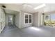 Inviting screened porch with a ceiling fan, skylight, and access door, ideal for relaxing and enjoying the outdoors at 115 Heatherwood Dr, Apex, NC 27502