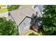 An aerial view of the back of the home showcasing a spacious deck and the surrounding trees and landscaping at 1230 Golden Bluff Ln, Fuquay Varina, NC 27526