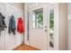 Bright entryway features coat hooks, hardwood floors, and a front door with sidelights at 1230 Golden Bluff Ln, Fuquay Varina, NC 27526