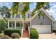 Charming two-story home with a red front door, covered porch, and landscaped front yard at 1230 Golden Bluff Ln, Fuquay Varina, NC 27526