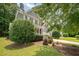 Charming two-story home with a welcoming front porch, a well-manicured lawn, and lush landscaping at 1230 Golden Bluff Ln, Fuquay Varina, NC 27526