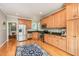 Bright kitchen with stainless steel appliances, granite countertops, and hardwood floors at 1230 Golden Bluff Ln, Fuquay Varina, NC 27526