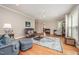 Comfortable living room features hardwood floors, a ceiling fan, and ample seating at 1230 Golden Bluff Ln, Fuquay Varina, NC 27526