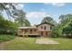 Exterior shot of a home's rear elevation and backyard, with a deck and a patio area for outdoor enjoyment at 1308 Swallow Dr, Raleigh, NC 27606