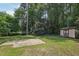 Backyard featuring grass, shed, and mature trees at 1308 Swallow Dr, Raleigh, NC 27606