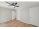 Bedroom with wood-look flooring and neutral walls, offering access to closets and other rooms at 1308 Swallow Dr, Raleigh, NC 27606