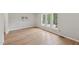 Bright bedroom featuring new hardwood floors and a large window with outdoor view, allowing plenty of natural light at 1308 Swallow Dr, Raleigh, NC 27606