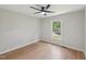 Bedroom with wood-look flooring and neutral walls, providing natural light through a window at 1308 Swallow Dr, Raleigh, NC 27606