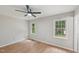 Bright bedroom featuring a ceiling fan, neutral walls, and natural light from two windows at 1308 Swallow Dr, Raleigh, NC 27606