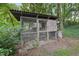 Chicken coop and run sitting in the yard at 1308 Swallow Dr, Raleigh, NC 27606