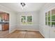 Cozy dining room with hardwood floors, light gray paint and a view to the backyard and kitchen at 1308 Swallow Dr, Raleigh, NC 27606