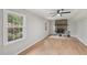 Comfortable living room featuring hardwood floors, a stone fireplace and an oversized window with outdoor views at 1308 Swallow Dr, Raleigh, NC 27606