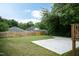 View of the backyard with a new concrete patio and a wooden privacy fence at 1318 N Alston Ave, Durham, NC 27701