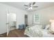 Cozy bedroom with ensuite bath access, ceiling fan, natural light, and hardwood floors for a serene retreat at 1318 N Alston Ave, Durham, NC 27701