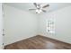Bright bedroom with a ceiling fan, window, and beautiful hardwood flooring at 1318 N Alston Ave, Durham, NC 27701