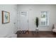 Bright entryway featuring white walls, hardwood floors, and a charming floral rug at 1318 N Alston Ave, Durham, NC 27701