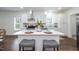 Well-lit kitchen with white cabinetry, stainless steel appliances, and stylish island seating at 1318 N Alston Ave, Durham, NC 27701
