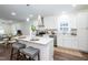 Open kitchen with white cabinets, a center island, and modern stainless steel appliances at 1318 N Alston Ave, Durham, NC 27701