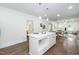 Bright open-concept kitchen features white cabinetry, an island with seating, and hardwood floors throughout at 1318 N Alston Ave, Durham, NC 27701