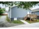 Rear view of a house with blue siding, a walkout basement, and wooden deck at 1318 N Alston Ave, Durham, NC 27701