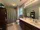 Bathroom featuring double vanity, shower with curtain, and decorative shelving unit at 148 Langston Ridge Dr Dr, Angier, NC 27501
