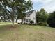 Landscaped front yard leading to a well-maintained two-story home with a charming covered entry at 148 Langston Ridge Dr Dr, Angier, NC 27501