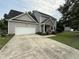 Charming two-story home featuring a gray exterior, attached garage and manicured lawn at 148 Langston Ridge Dr Dr, Angier, NC 27501