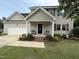 Inviting home entrance with a cozy porch, a decorative wreath, and well-maintained landscaping at 148 Langston Ridge Dr Dr, Angier, NC 27501