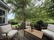 Inviting deck featuring cozy seating, a wooden table, and lush greenery, perfect for outdoor relaxation at 148 Langston Ridge Dr Dr, Angier, NC 27501