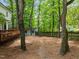 View of the backyard featuring trees, a privacy fence, a shed and pine straw ground cover at 15 Gray Fox Ct, Durham, NC 27713