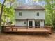 Two-story home showcasing a spacious deck overlooking a lush, tree-filled backyard at 15 Gray Fox Ct, Durham, NC 27713