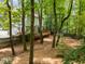 The backyard is fenced and features a deck, shed, and plenty of trees at 15 Gray Fox Ct, Durham, NC 27713