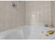 Close-up of bright bathroom featuring a corner soaking tub with tile surround at 15 Gray Fox Ct, Durham, NC 27713