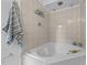 Bright bathroom featuring a corner soaking tub with tile surround and rainfall showerhead at 15 Gray Fox Ct, Durham, NC 27713