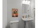 Charming bathroom with pedestal sink, decorative mirror, and stylish wall art at 15 Gray Fox Ct, Durham, NC 27713