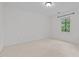 Empty bedroom with neutral carpeting, a window view, and a modern light fixture at 15 Gray Fox Ct, Durham, NC 27713