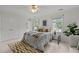Bright bedroom features neutral paint, carpet, large windows, modern furnishings, and ceiling fan at 15 Gray Fox Ct, Durham, NC 27713