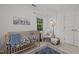 Bedroom with crib, rocking chair, plush rug, and natural light from a window at 15 Gray Fox Ct, Durham, NC 27713