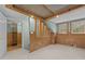 Large bonus room featuring unique wood details, bright windows, and access to a bonus closet at 15 Gray Fox Ct, Durham, NC 27713