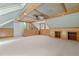 Spacious bonus room boasting wood-paneled walls with built-in shelves and plush neutral carpeting at 15 Gray Fox Ct, Durham, NC 27713