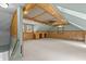 Spacious bonus room with vaulted ceilings, wood paneling, and built-in shelving at 15 Gray Fox Ct, Durham, NC 27713