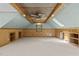 Light-filled bonus room featuring a unique ceiling, neutral carpet, and wood-paneled walls with built-in shelves at 15 Gray Fox Ct, Durham, NC 27713