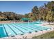 Large community pool with multiple lanes, a diving platform, and a shaded seating area at 15 Gray Fox Ct, Durham, NC 27713