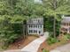 The exterior view of the home features mature trees, landscaping and a long driveway at 15 Gray Fox Ct, Durham, NC 27713