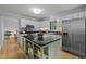 Spacious kitchen with island, stainless steel refrigerator, and white cabinets at 15 Gray Fox Ct, Durham, NC 27713