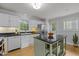 Bright kitchen with white cabinetry, stainless steel appliances, and center island at 15 Gray Fox Ct, Durham, NC 27713